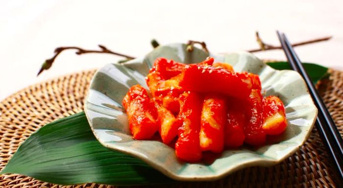 Curry tteokbokki combines rice and fish cakes with vegetables and eggs, all coated in curry sauce.