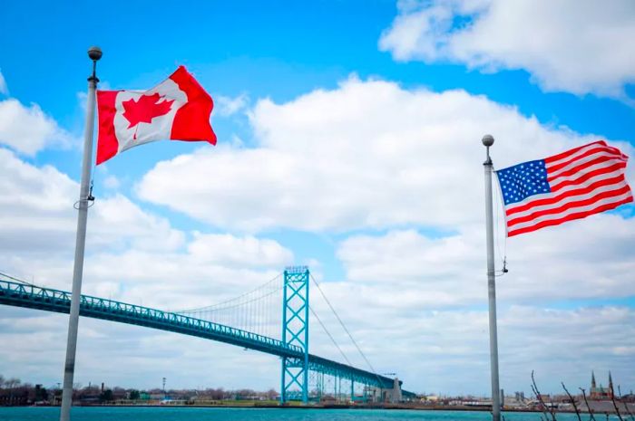 The Ambassador Bridge stretches across the Detroit River, connecting Windsor, Ontario to Detroit, Michigan.