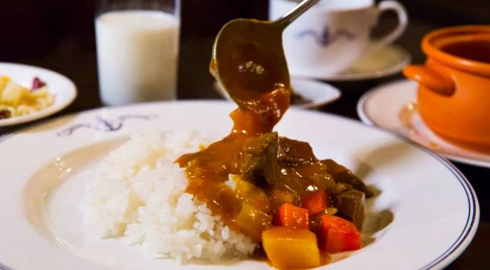 Japan's hearty and smooth curry often contains tender chunks of stewed beef, onions, and carrots, all served over a mound of rice.