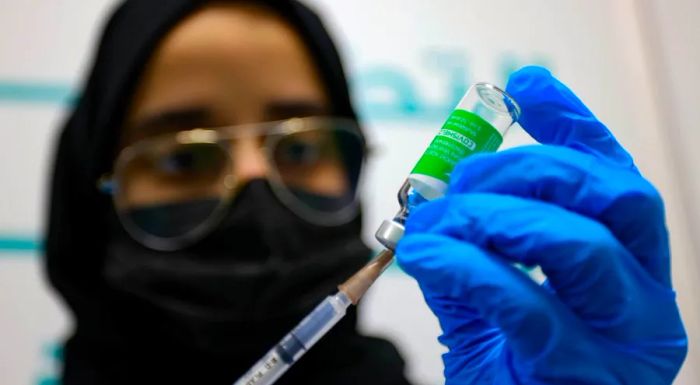 A health worker in Dubai is seen preparing a dose of the Oxford-AstraZeneca vaccine in February 2021.