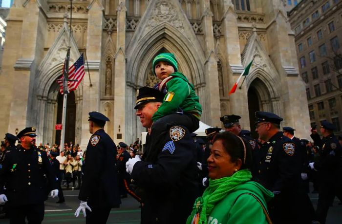 In 2016, a New York City police officer marched with his son past St. Patrick's Cathedral during the iconic St. Patrick's Day Parade in Manhattan.