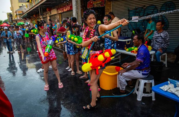 Festival-goers engage in a water fight on Khao San Road on April 13, 2023.