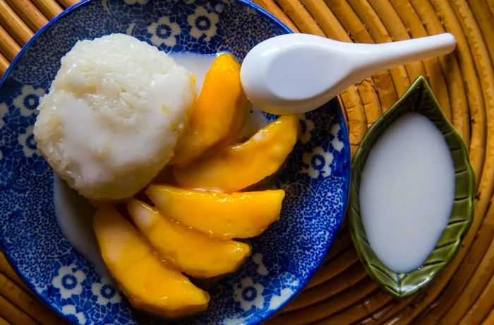 A beloved Thai classic: mango served with sticky rice and drizzled with creamy coconut sauce.