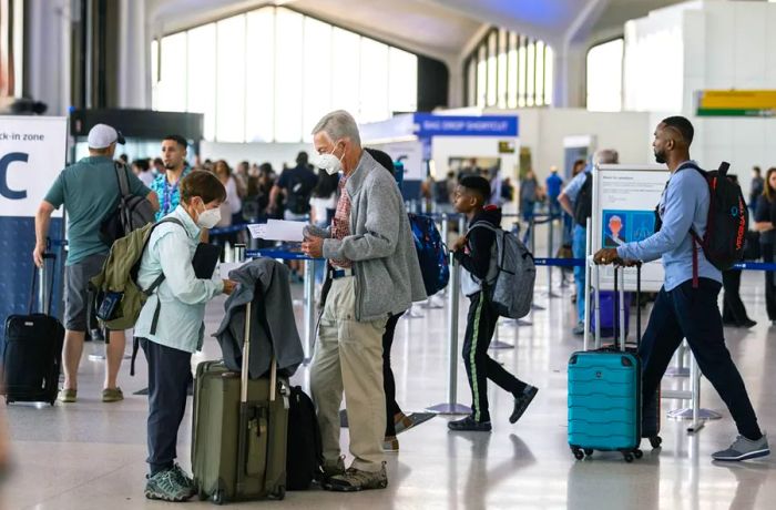 Travelers queue to check in at Newark Liberty International Airport on July 1. Newark ranks as the world’s 2nd airport for cancellations this summer.