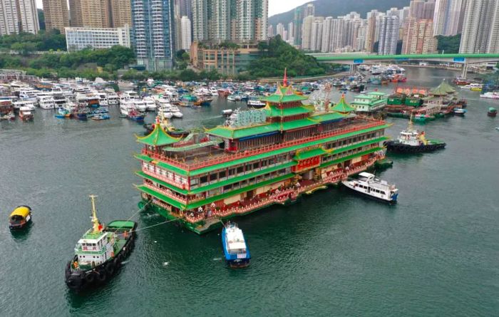 Hong Kong's iconic Jumbo Floating Restaurant, styled like a Chinese imperial palace but showing signs of age, is towed out of Aberdeen Harbor on June 14, 2022.