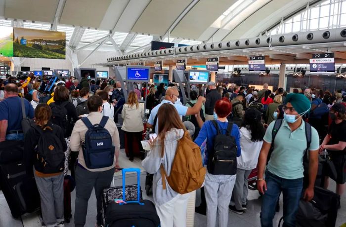 Travelers were seen waiting in long lines at Toronto Pearson International Airport on June 30, 2022, as more than half of the airport's flights were delayed.