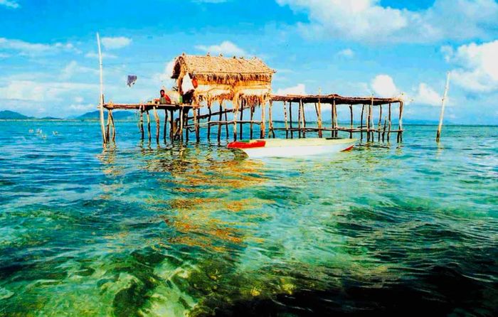 A sea-hut floating in the crystal-clear waters near Sipadan Island.