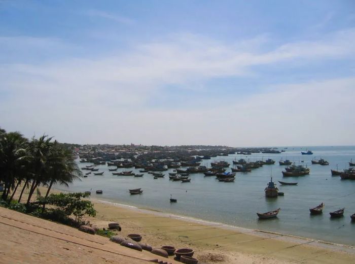 Fishing boats docked on the shores of Mui Ne beach.