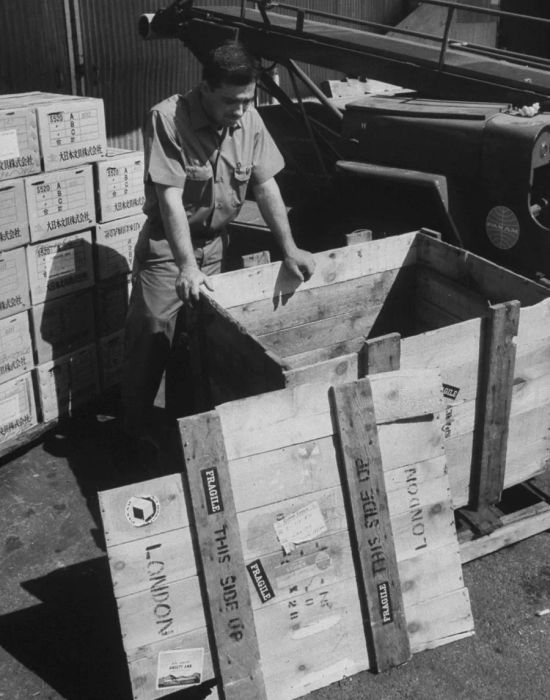 A Pan Am staff member inspects the crate where Brian Robson was found in 1965.