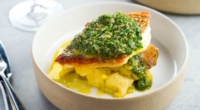 Black bass with salsa verde and coal-roasted potatoes at Lilia.