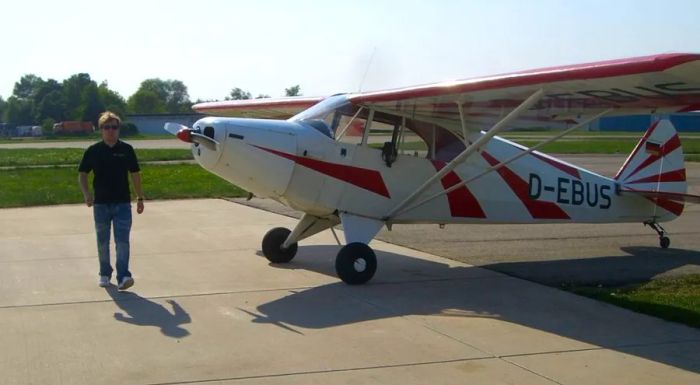 Klaus with the Piper PA-12 airplane that he took Sallie on their flight.