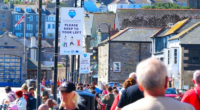 Crowds pack the streets of St Ives, a picturesque seaside town in Cornwall, UK.