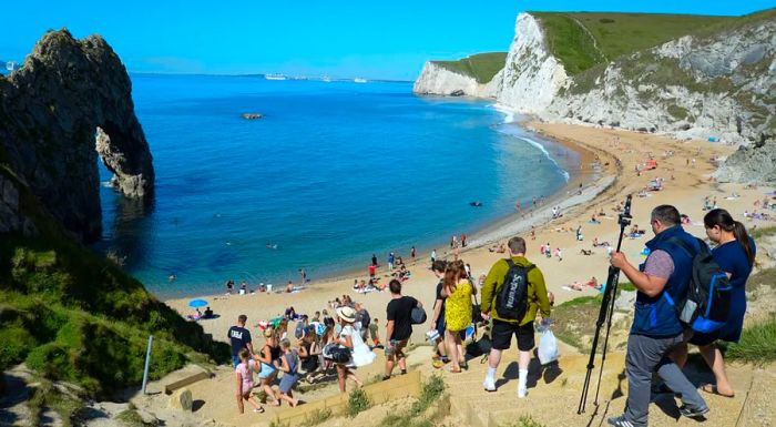 Crowds flock to Durdle Door beach in Dorset.