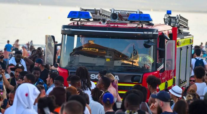 A fire truck struggles to navigate through the crowds along Bournemouth's promenade in June.