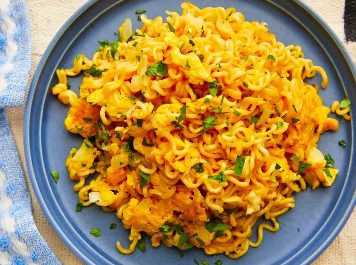 A top-down view of a plate filled with ramen scrambled eggs.