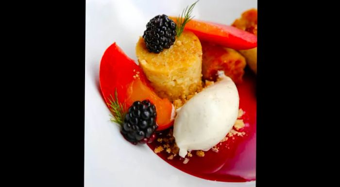 Cornbread pudding with peaches, blackberry caramel, and buttermilk.