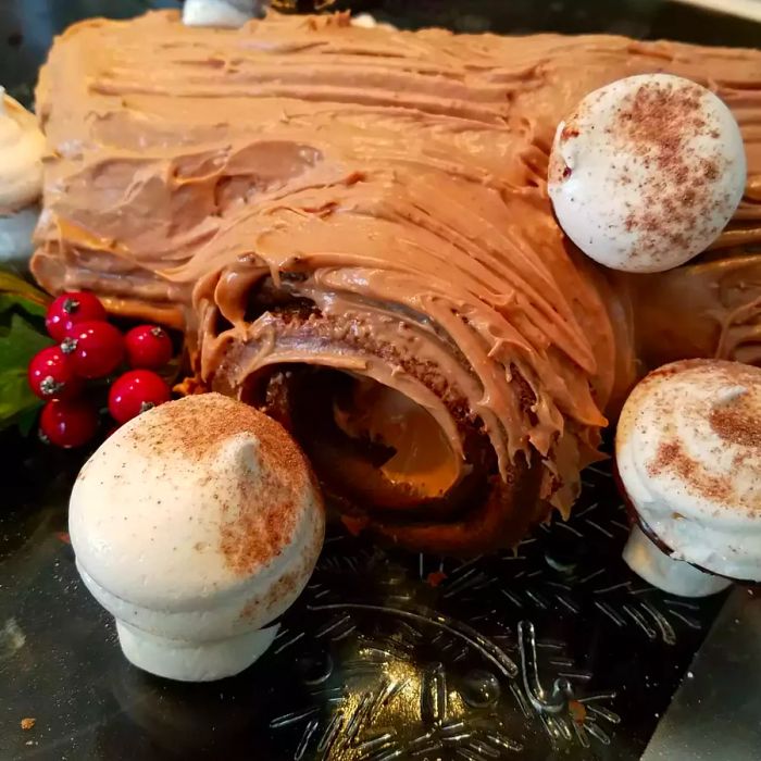 Yule log adorned with meringue mushrooms