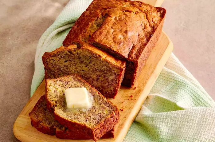 A loaf of Banana Banana Bread topped with butter