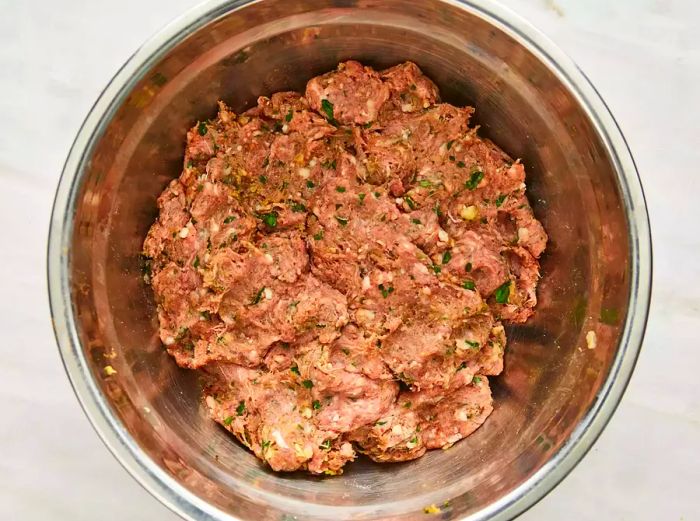 Top-down shot of the meat mixture in a bowl, ready for shaping into kofta kebabs