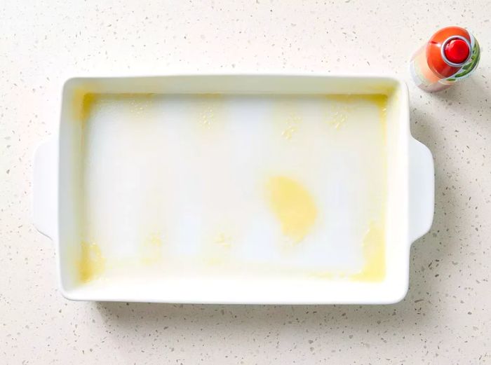 A baking dish sprayed with cooking spray.