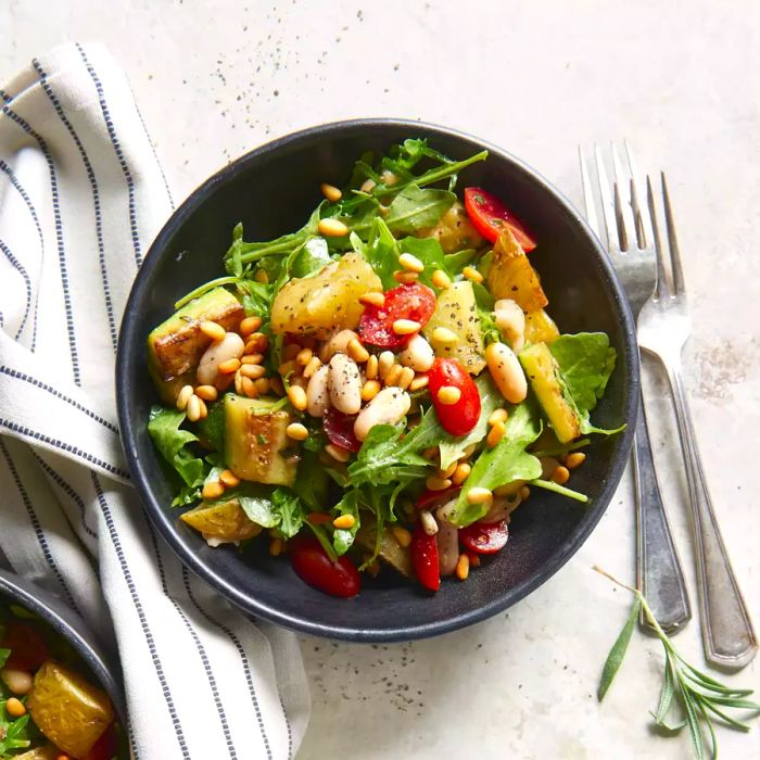 A hearty roasted vegetable bowl on a clean white background.