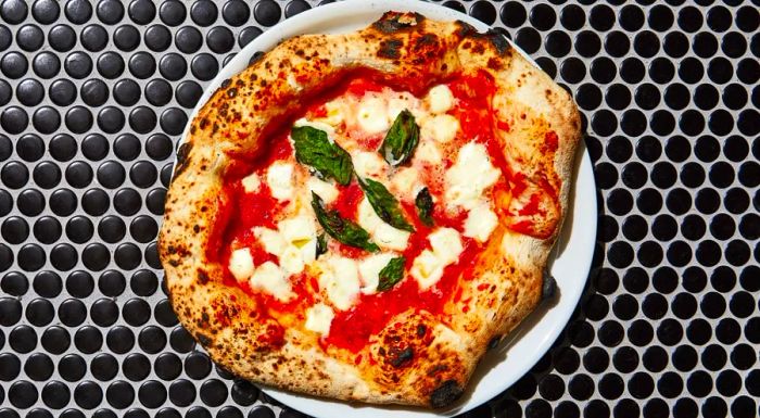 When it comes to the Margherita at Una Pizza Napoletana, it’s all about the foundation—the base is the star of this classic pizza.