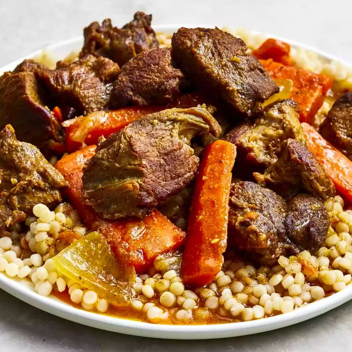 A mid-shot view of a plate filled with lamb tagine.