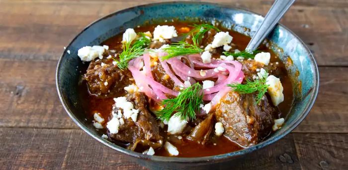 Greek-Style Beef Stew (Stifado) Recipe served in a white bowl.