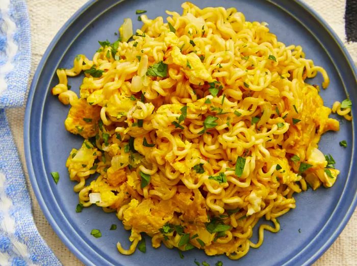 A close-up of a plate of ramen scrambled eggs.