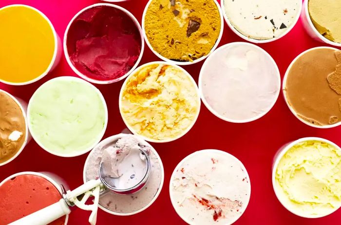 An overhead shot of a variety of ice cream flavors in cartons