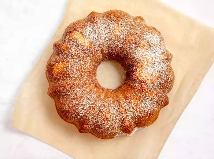 A cream cheese pound cake sitting on kraft paper.