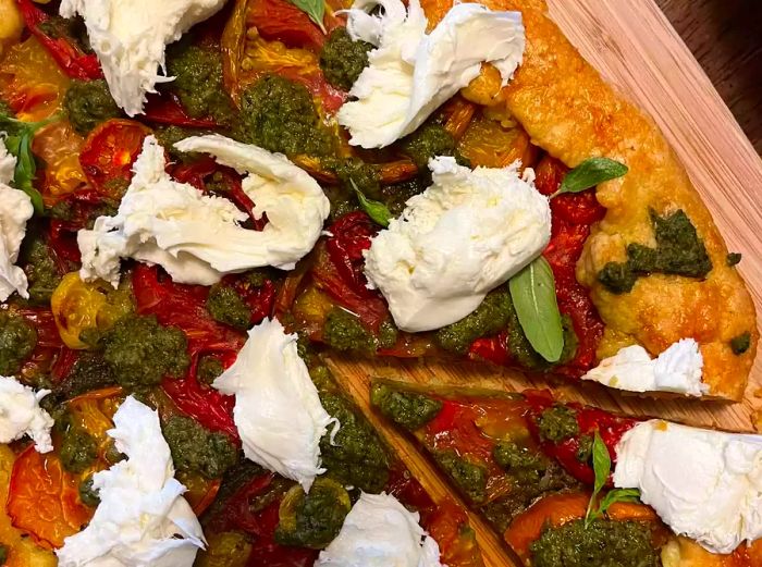 A close-up of a beautifully baked tomato galette.