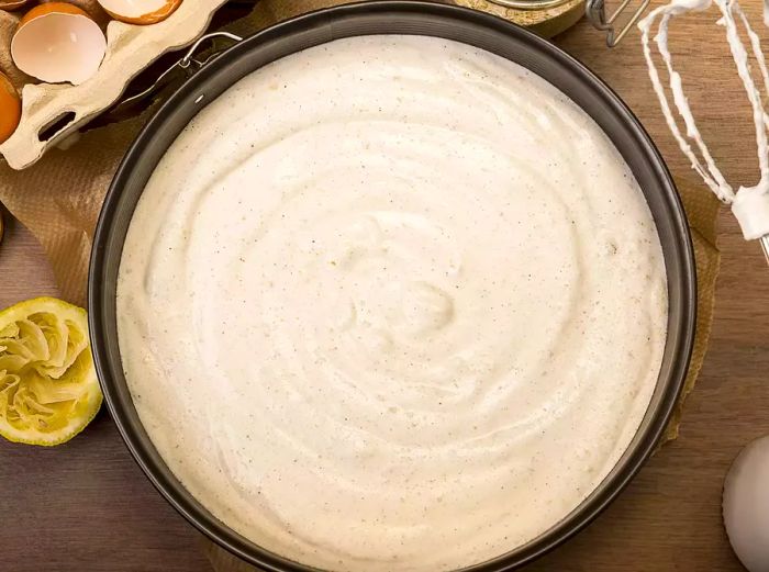 Aerial view of cheesecake batter in a cake pan