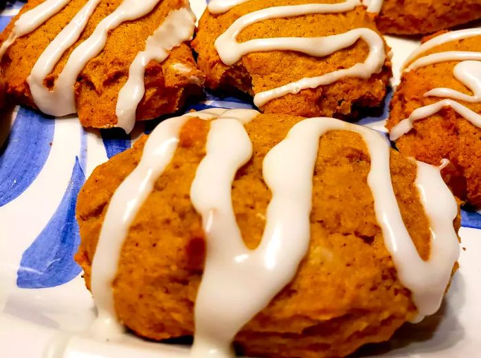 Iced Pumpkin Cookies on a Blue and White Plate