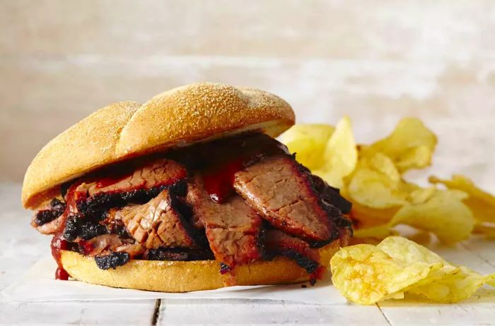 Beef brisket served on a sandwich with chips