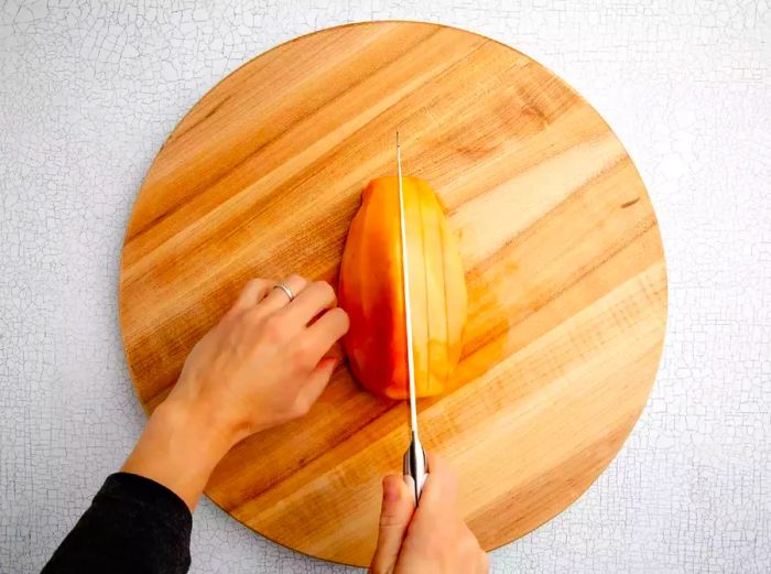 slicing papaya into pieces