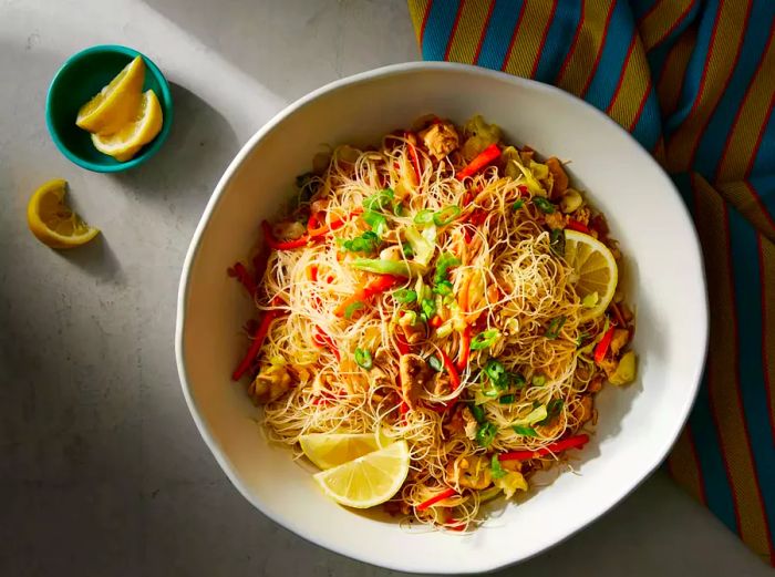 viewing a serving of pancit, beautifully garnished with lemon wedges