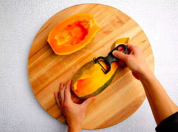 peeling the skin off papaya