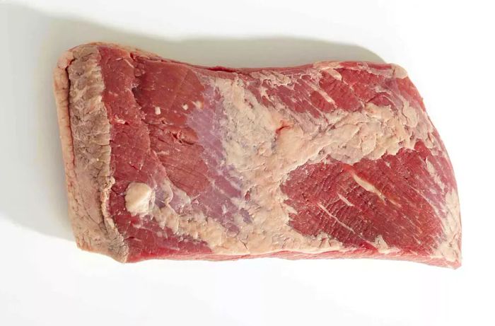 Raw brisket on a white background