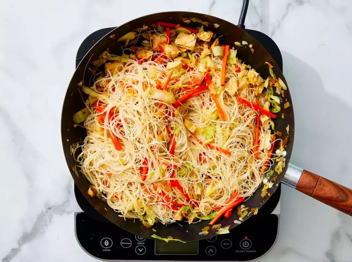 noodles added to the skillet, stirring constantly to combine