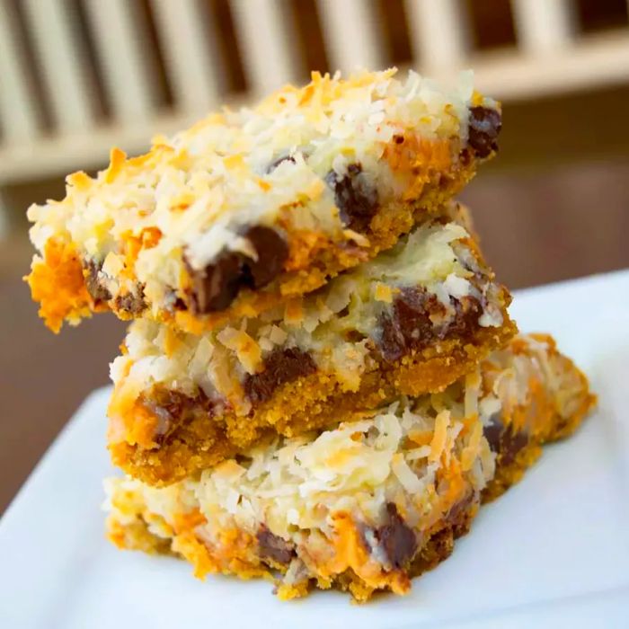 A close-up shot of a stack of Seven Layer Bars served on a plate.