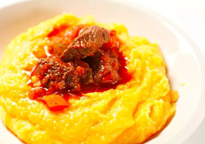 Creamy Polenta Topped with Beef and Rich Red Sauce