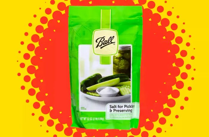 Ball pickling salt in a green package, set against a red, orange, and yellow burst background