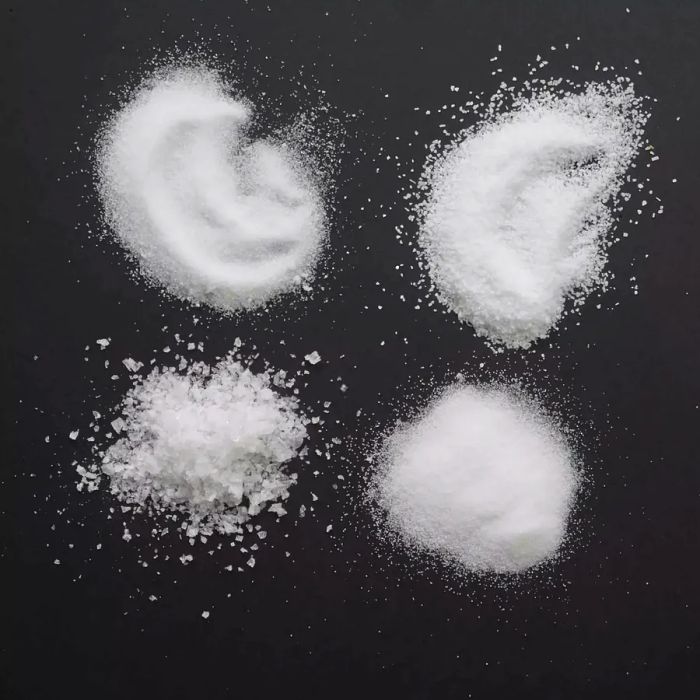 various types of salt on a black surface