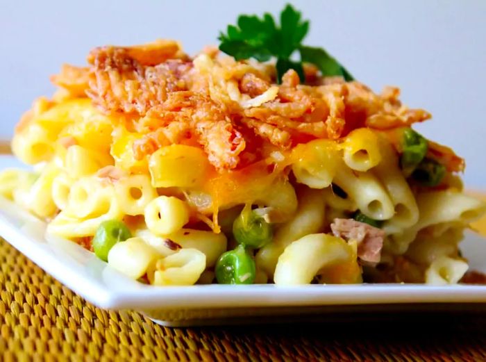 A serving of classic tuna casserole on a white square plate.