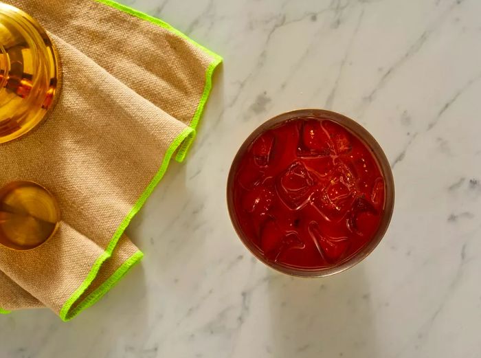 Top-down view of a shaker filled with Bloody Mary ingredients and ice.