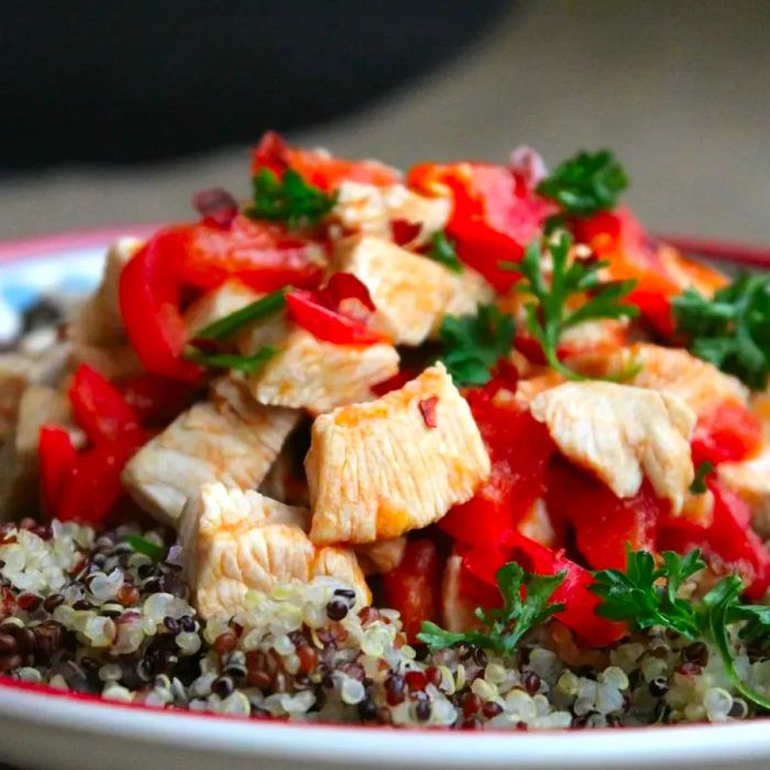 Chicken with Red Peppers and Tomatoes Served Over Quinoa