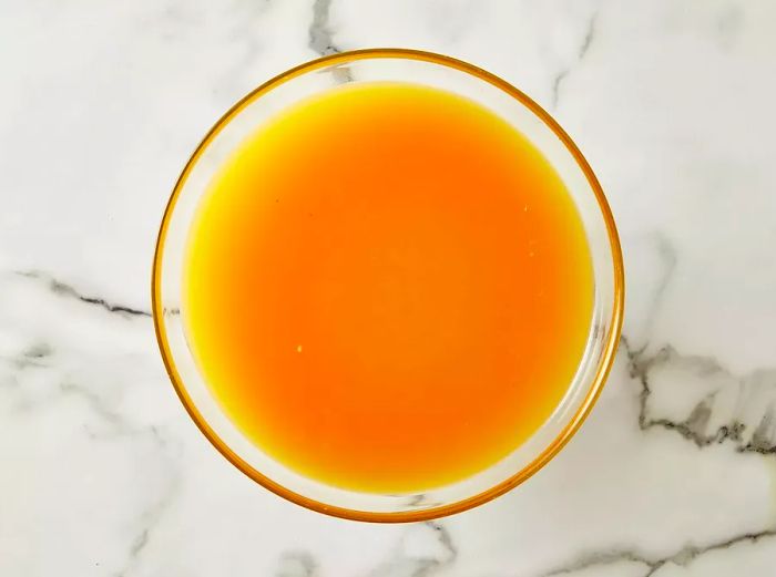 Aerial view of the rum punch mixed and settling in a glass bowl.