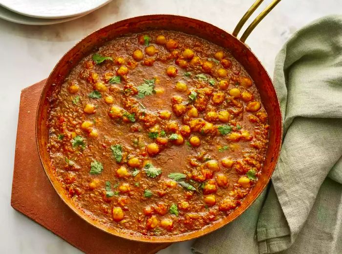 A top-down view of a skillet of Chana Masala