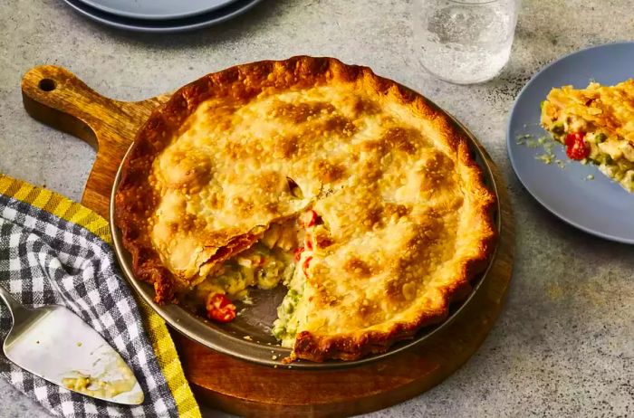 A freshly cut slice of chicken pot pie in a skillet